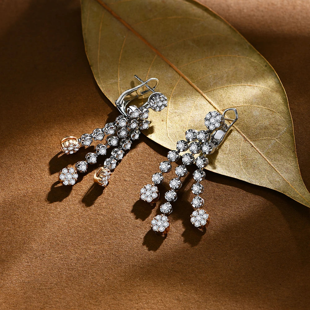Elegant diamond earrings on a brown leaf