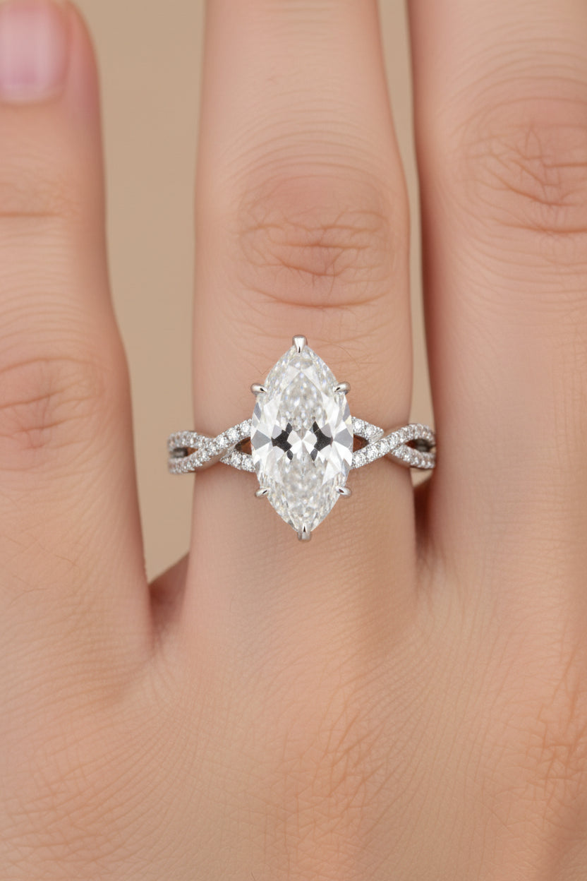 Silver ring with heart-shaped gemstone on a hand, with a close-up of the ring on a dark surface.