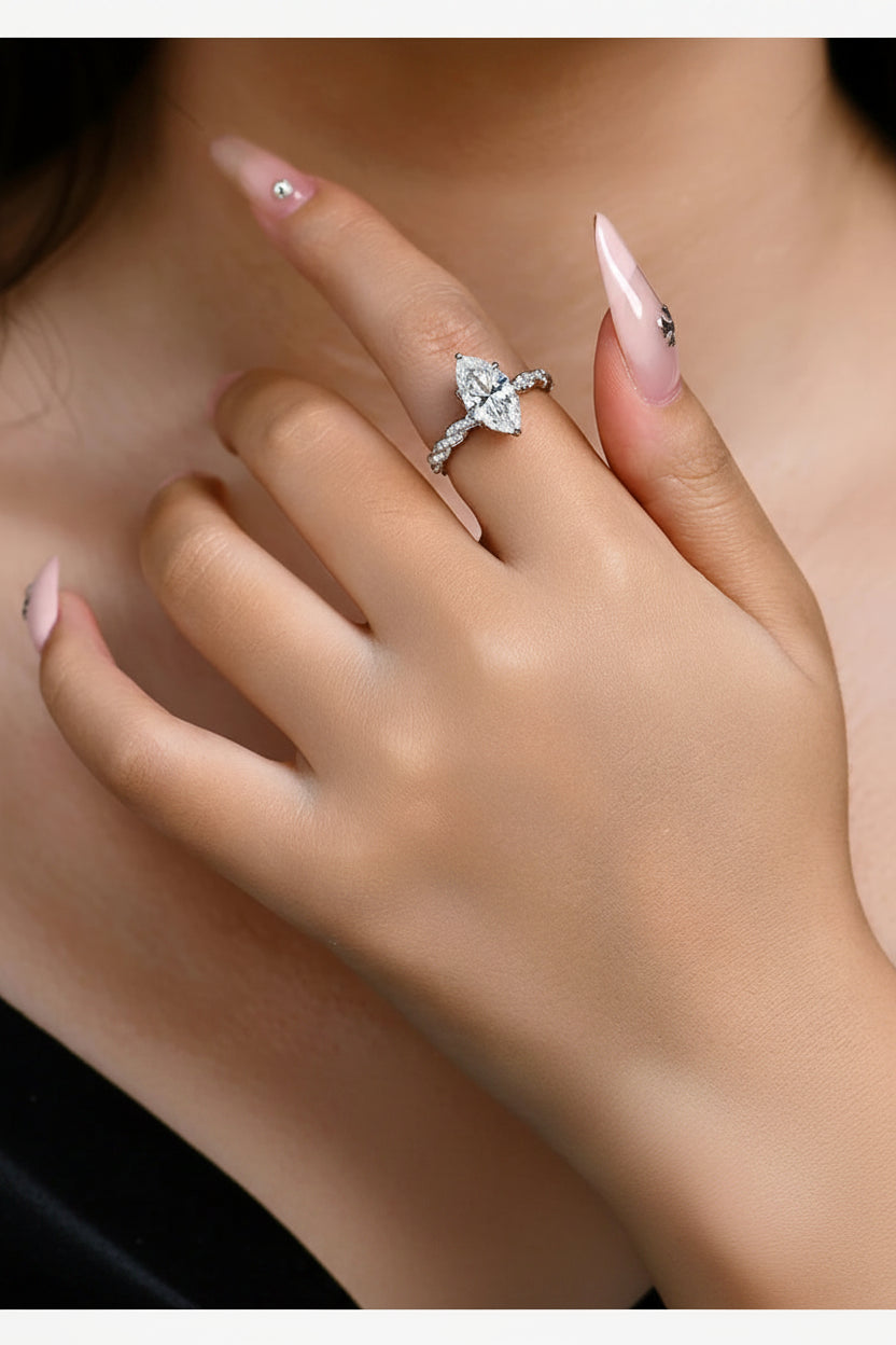 Close-up of a hand wearing a diamond ring with a blurred background